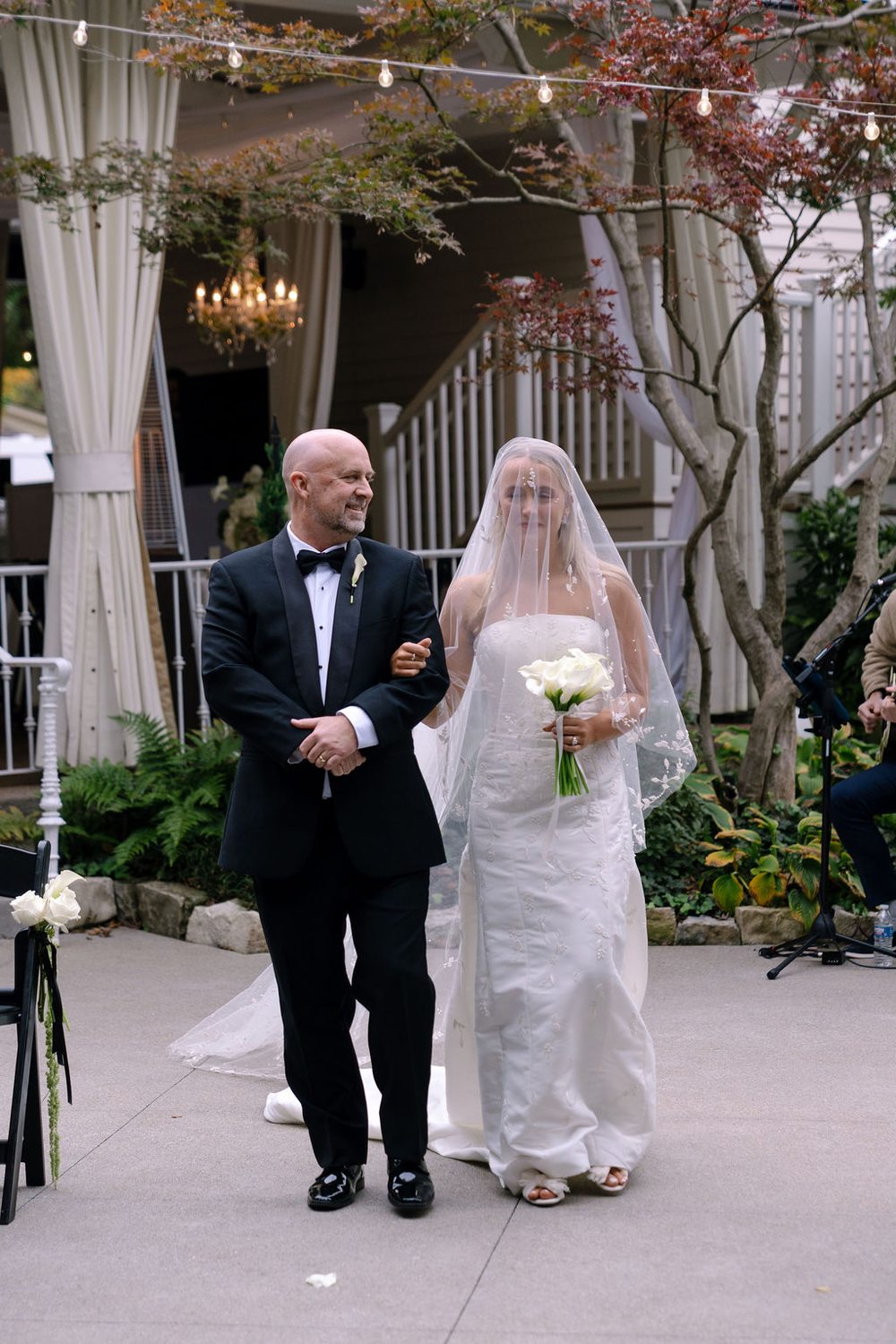 Addison walking down the aisle at her November garden wedding