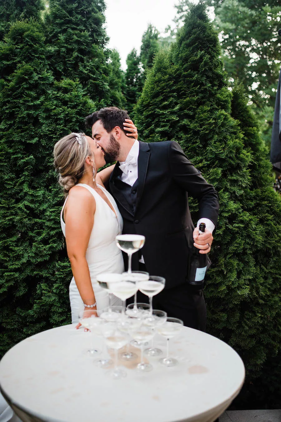 Bride and groom walking through a romantic garden for their wedding ceremony at outdoor wedding venue CJ’s Off the Square (Franklin, TN).