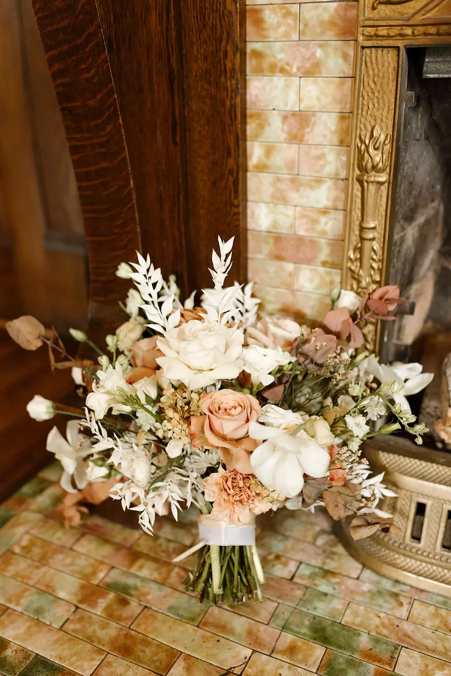 Simple but elegant wedding cake with buttercream icing and fresh flowers and greenery at garden wedding venue CJ’s Off the Square near Nashville, TN. 