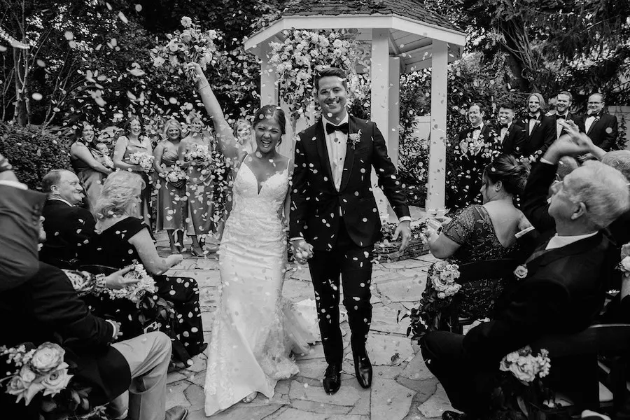 * Bride and groom walking through a romantic garden for their wedding ceremony at outdoor wedding venue CJ’s Off the Square (Franklin, TN). 