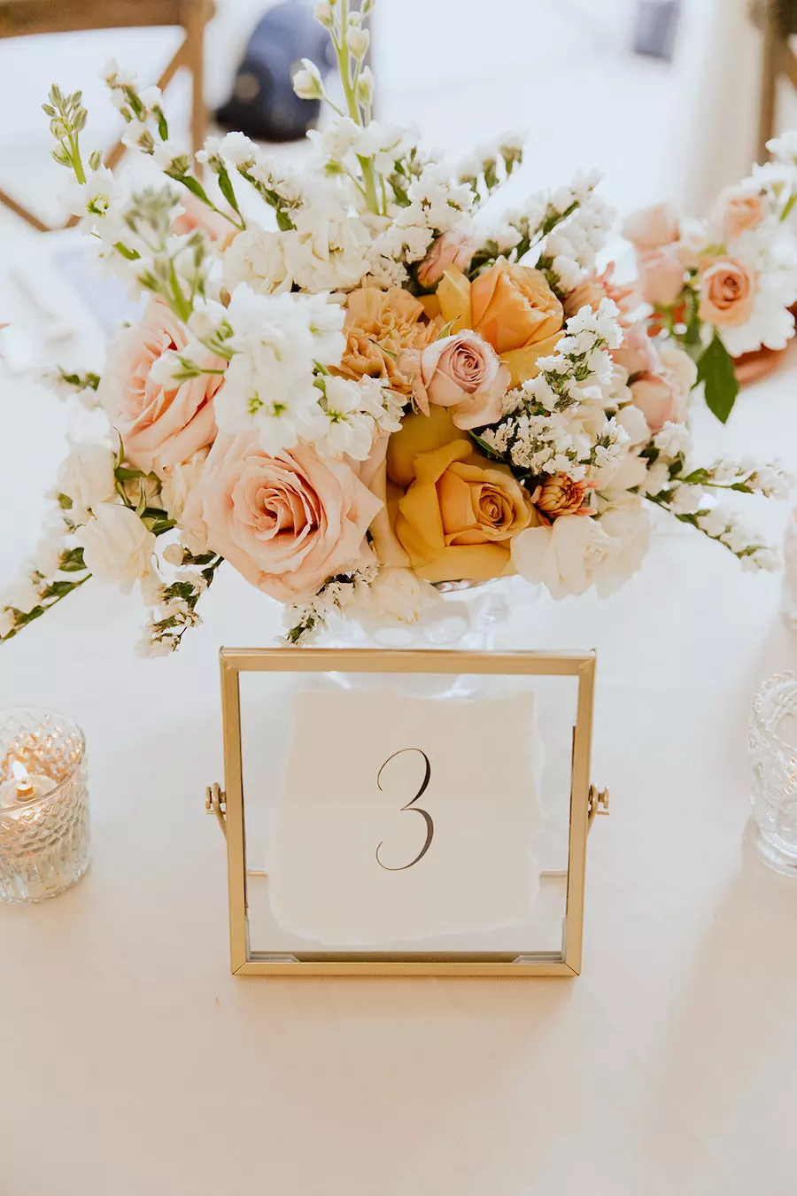 * Farm table with white runner, greenery and candles in neutral wedding colors at Nashville wedding venue CJ’s Off the Square. 