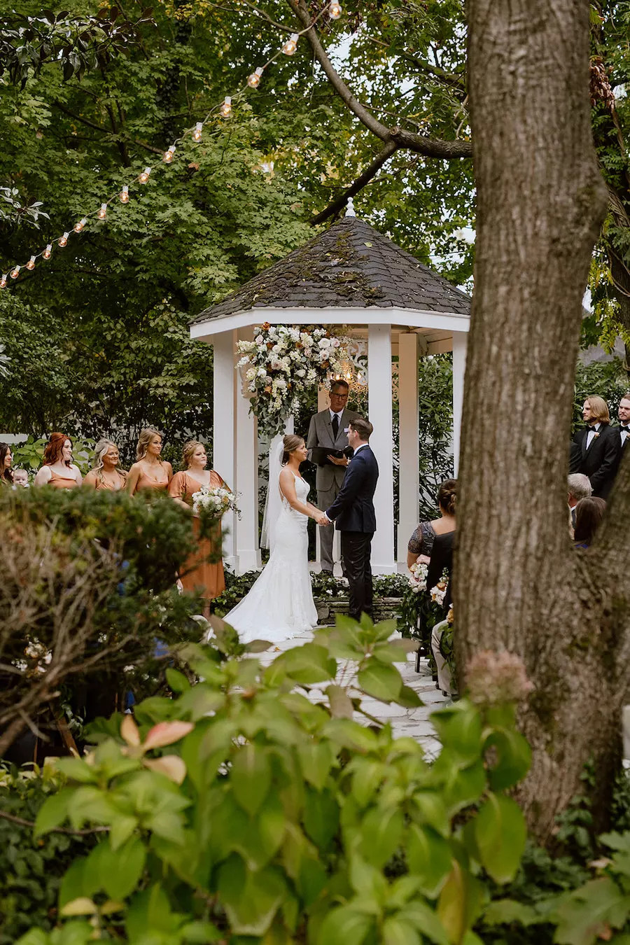 * Bride and groom walking through a romantic garden for their wedding ceremony at outdoor wedding venue CJ’s Off the Square (Franklin, TN). 