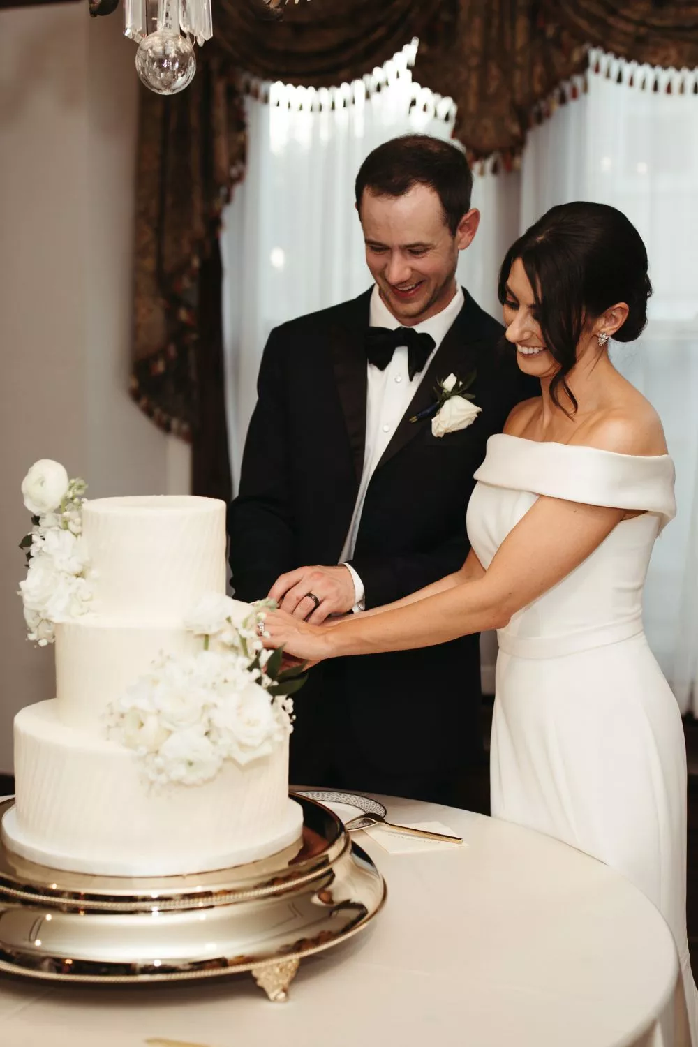 bride and groom cutting cake at CJ's Off the Square